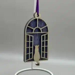 A Cat looking through a window suncatcher